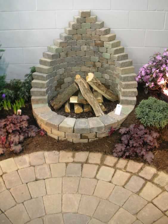  This DIY fire pit's teardrop-shaped design is ideal for one not being positioned in a central space. Via Homestead Lifestyle