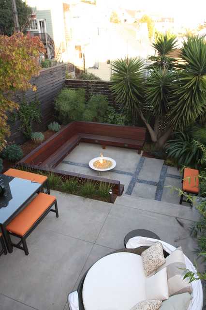A dish-shaped fire pit adds a futuristic element to this geometric backyard. Via Outer Space Landscape Architects