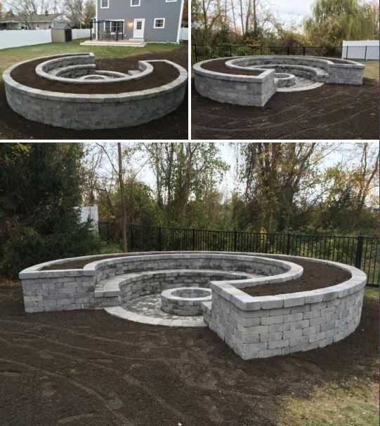 This elegant fire pit design comes with matching built-in seating and garden planter. Via Jersey Coast Landscaping