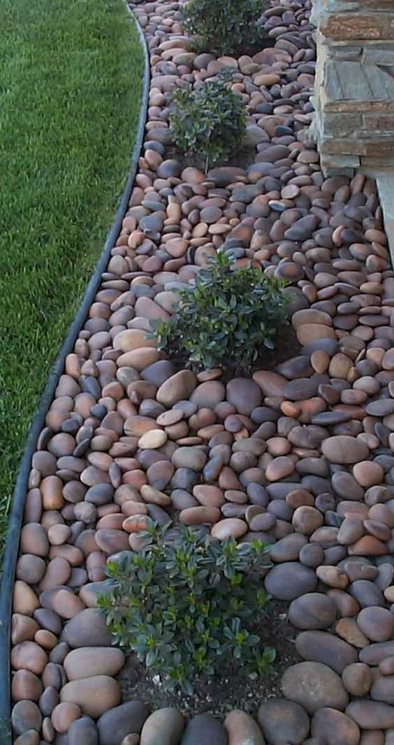 Use large pebbles rather than mulch to keep your garden beds looking chic and tidy. Via Livin King