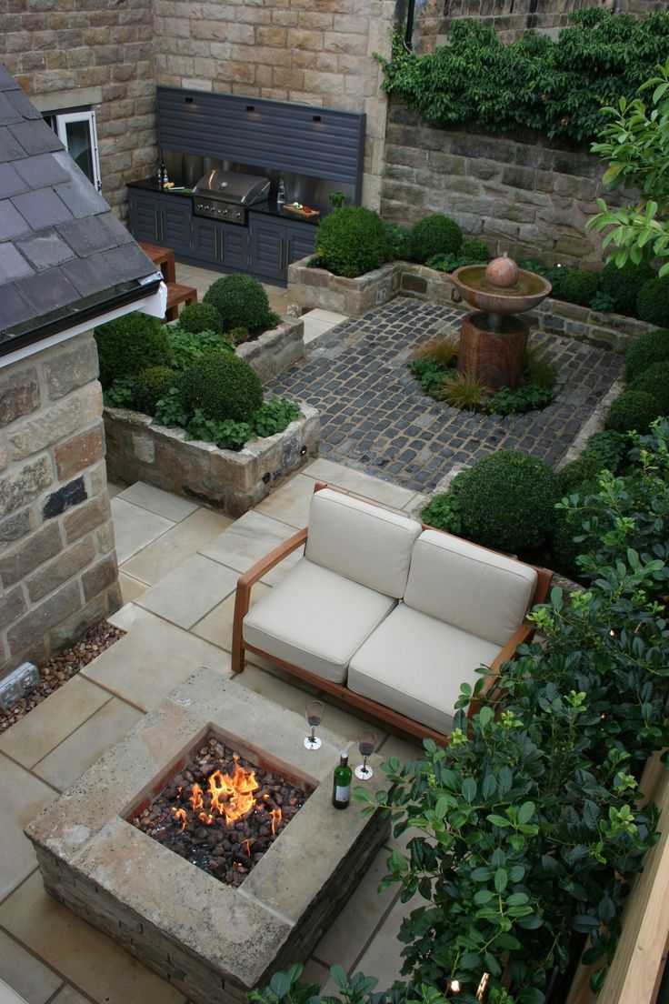 This solid stone fire pit marks out a small haven for relaxation in this courtyard. Via Renoguide
