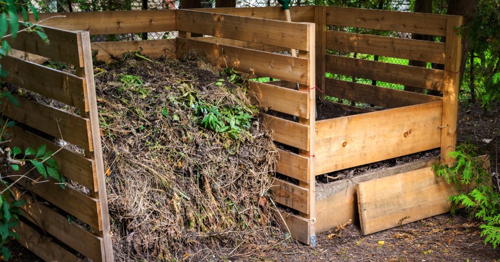 A picture of a composting garden bed with shredded bark and wood chips after years of breaking down.